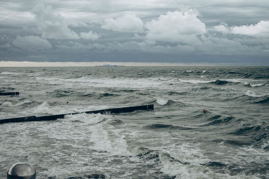 A captivating view of the stormy sea with rough waves and thick clouds overhead, showcasing nature's power.